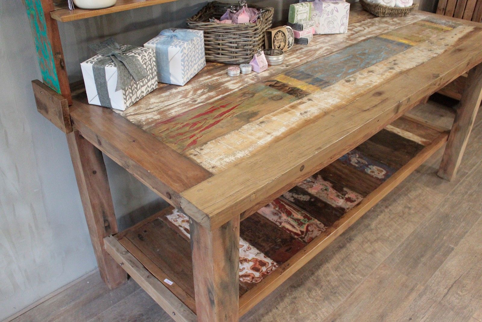 Recycled teak wood dining table with top shelf featuring a rustic reclaimed wood farmhouse patchwork top in earthy tones