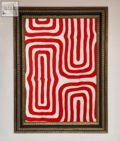 Red waves abstract art framed in an ornate gold toned frame featuring red and white textile design