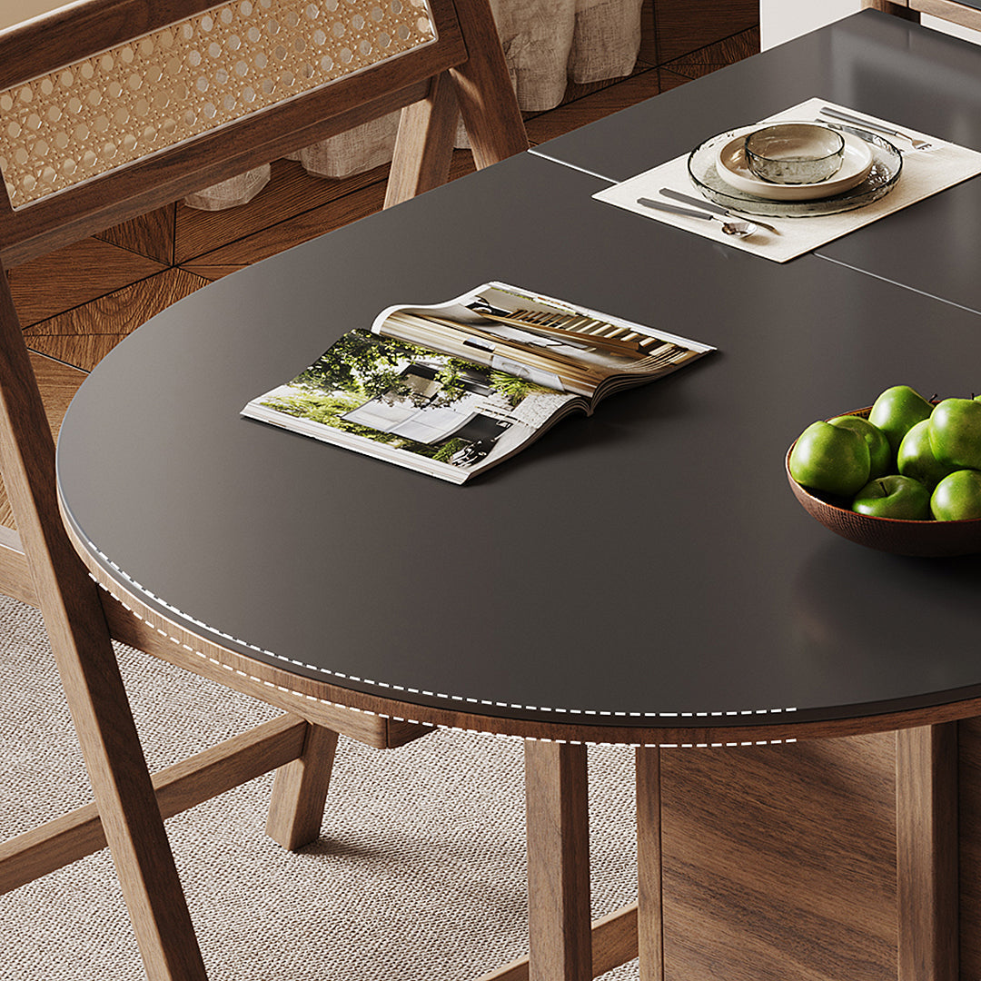 Black round table mat with white dashed stitching on reddy fold dining table with walnut sideboard