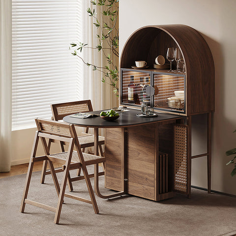 Dark wood arched bar cart with glass storage and woven cane accents complements reddy fold dining table in walnut