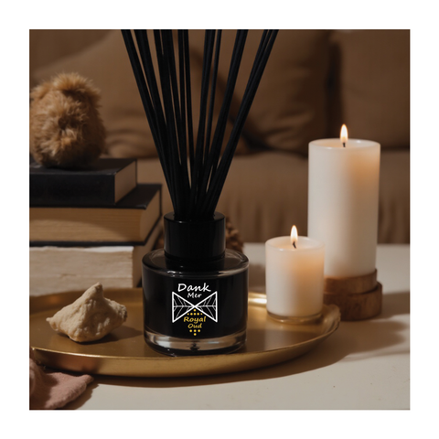 Black glass reed diffuser bottle with dank mer royal oud label and black reed sticks in a reed diffuser set