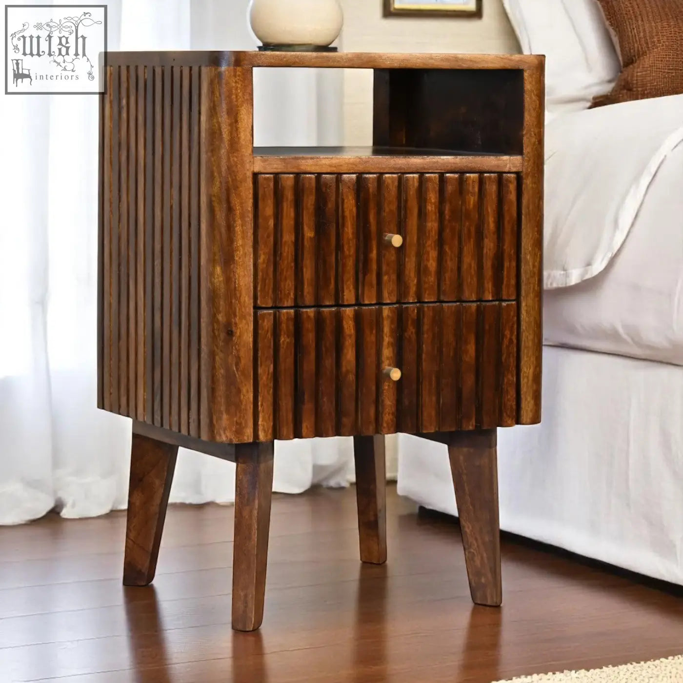Dark wood reeve bedside table with ridged drawer fronts made from solid mango wood and brass round knobs