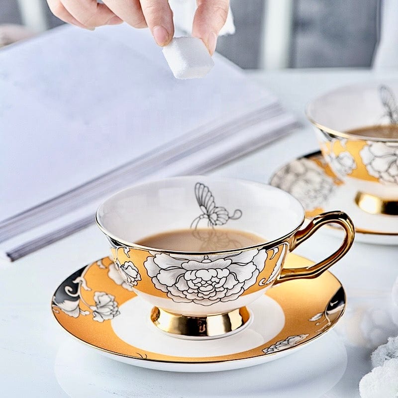 Elegant regal bloom bone china teacup and saucer with gold white floral and butterfly design
