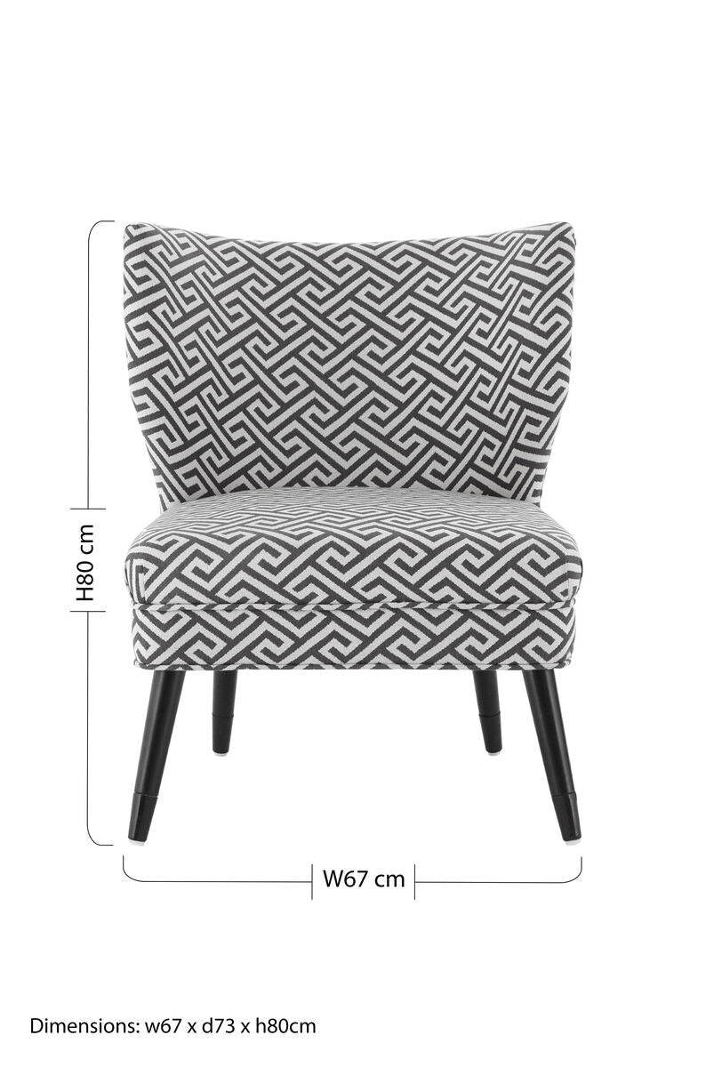A modern regents park greek key design accent chair with black and white geometric upholstery and sleek black legs