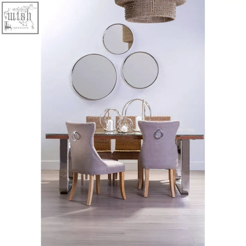 Light gray regents park mink linen dining chair with silver ring pulls on backrests and light wooden legs