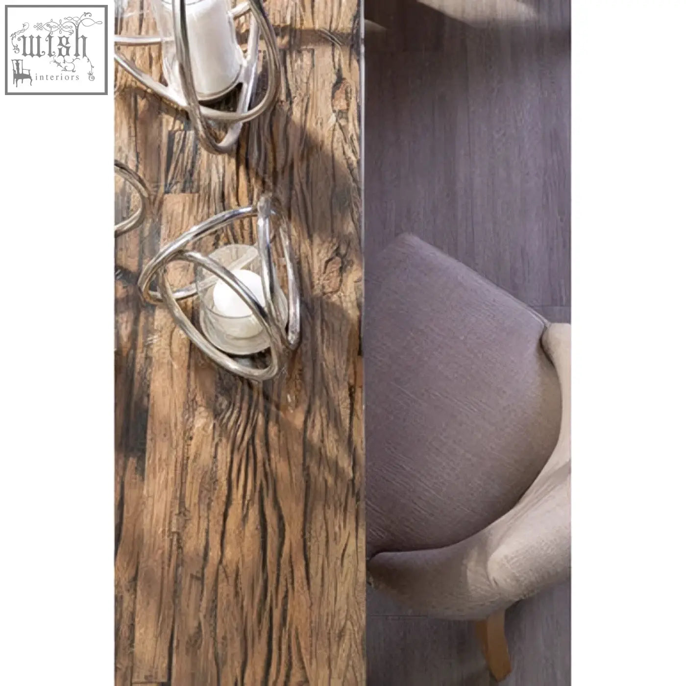 Silver wire candle holders with modern cage design paired with mink linen dining chair with light wooden legs