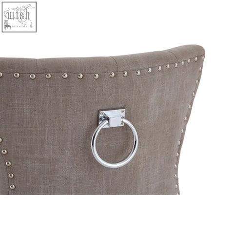 The back of a regents park mink linen dining chair with taupe mink linen fabric silver ring handle and light wooden legs