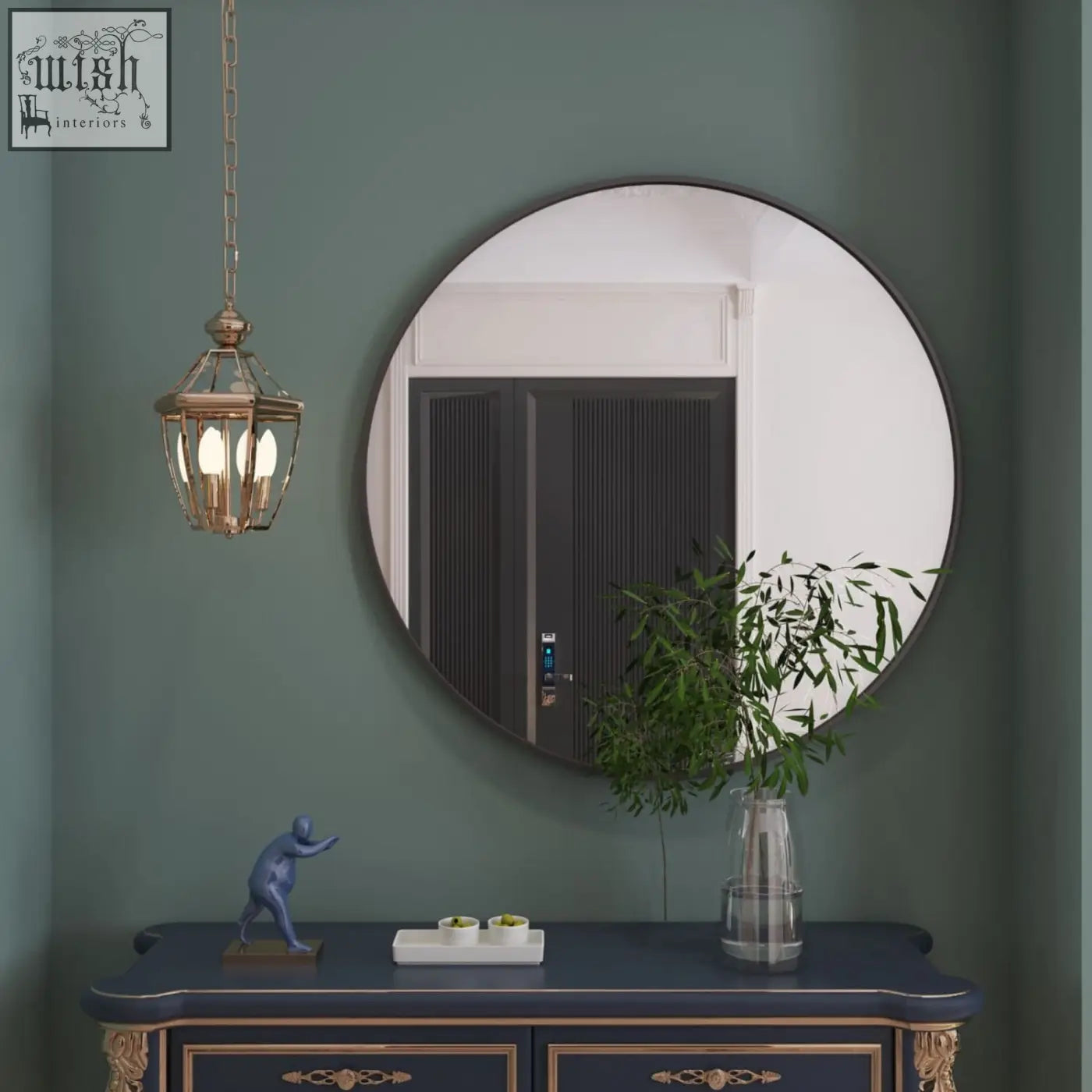 Rei 90cm black metal round wall mirror with large black frame hanging on a green wall