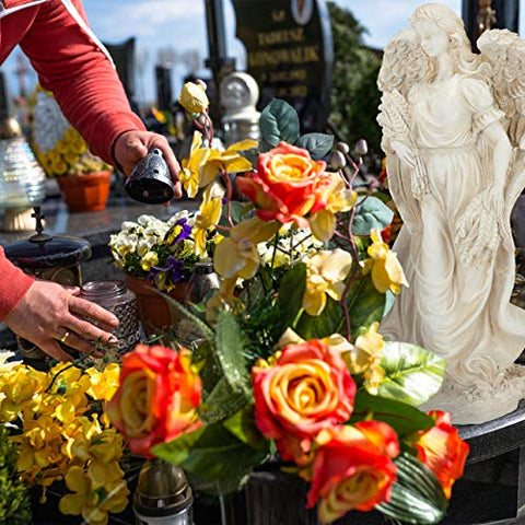 A cream-white polyresin relaxdays garden ornament angel with outstretched wings beside vibrant roses for indoor outdoor use