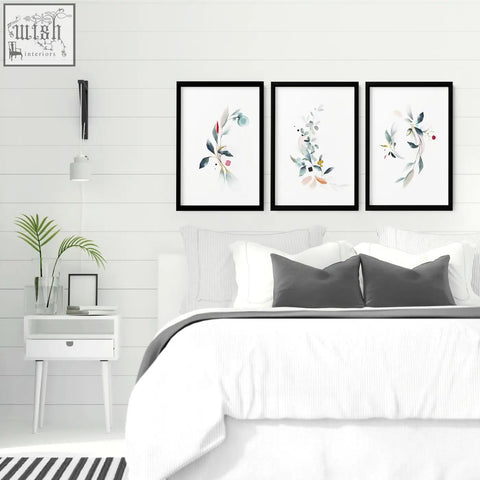 Three black-framed botanical bedroom wall art prints with watercolor greenery and pink red gold accents for relaxing decor