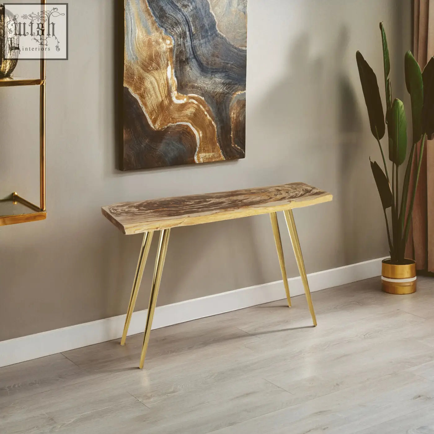 A relic petrified wood console table with a natural wood top and slender gold metal legs for stylish storage