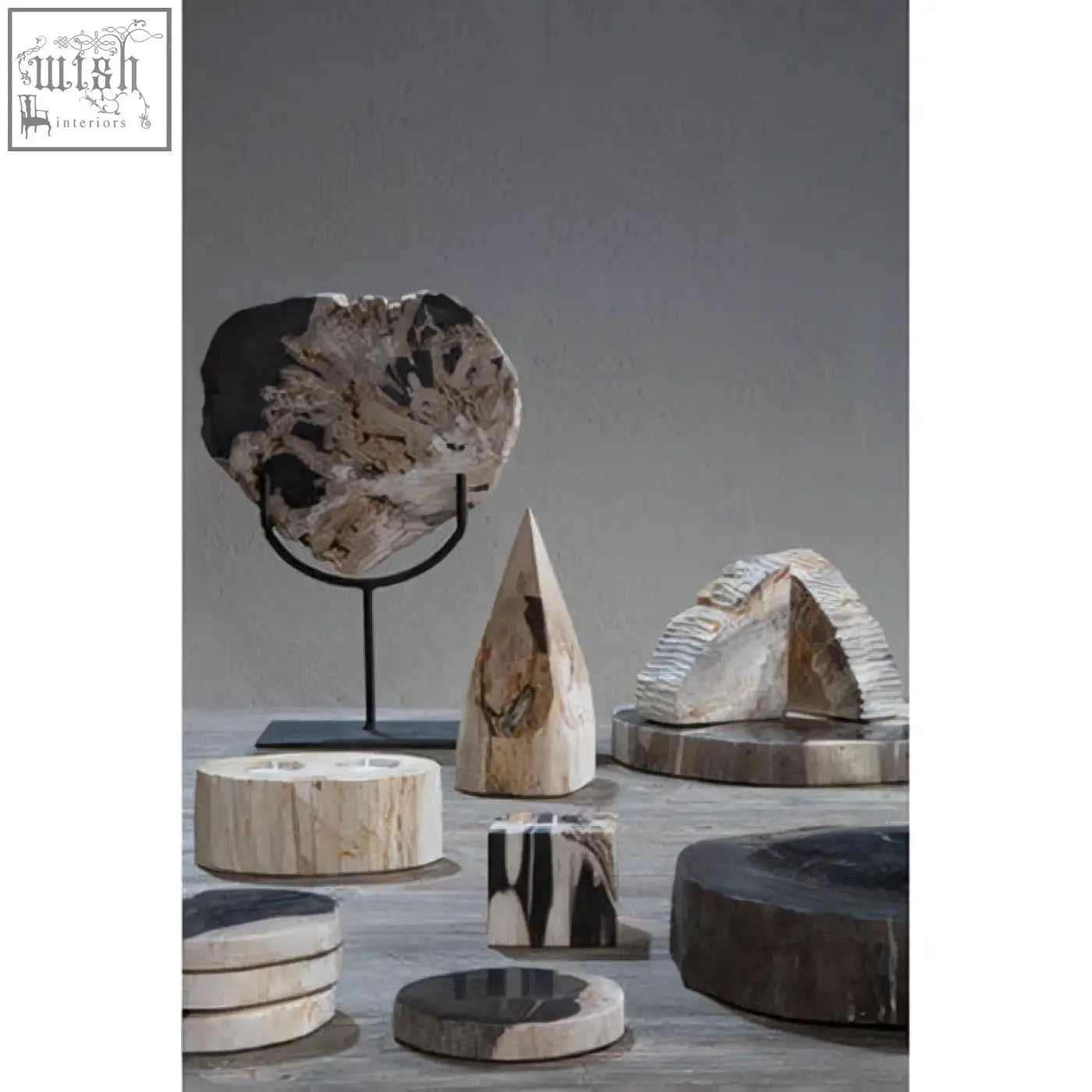 A polished circular petrified wood coaster with beige and dark brown swirls for the relic wood pyramid sculpture