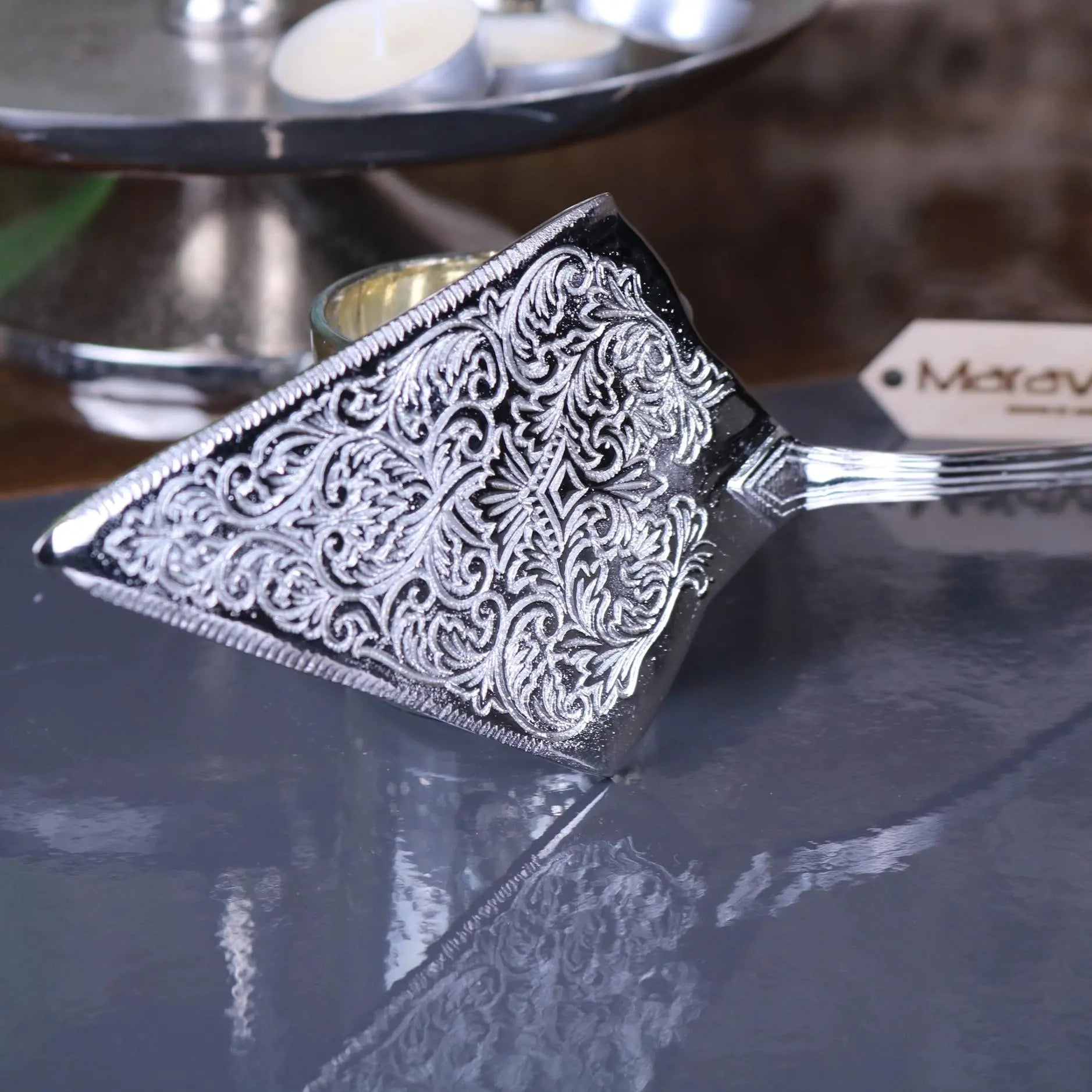 Silver plated cake server with intricate floral engraving and polished finish perfect for serving desserts