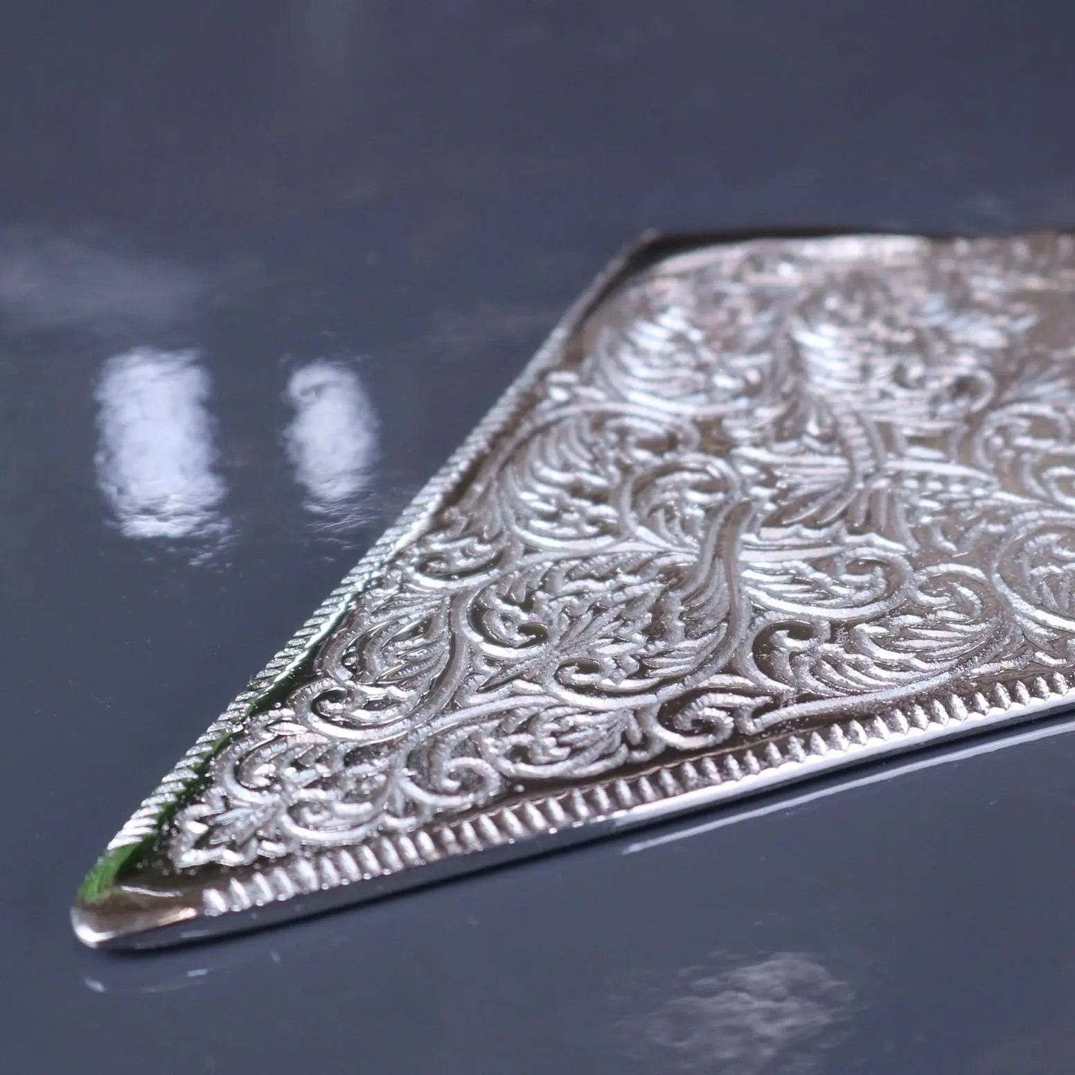 Silver plated cake server with intricate floral embossing and beveled edges by replica kings for serving cake