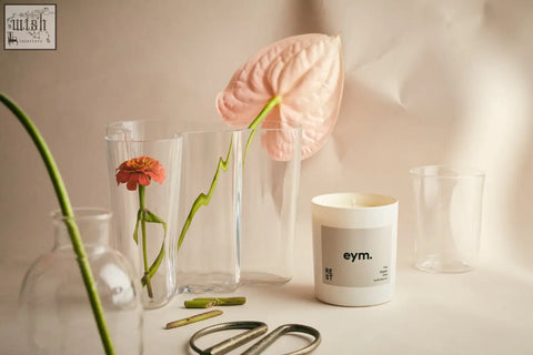 White cylindrical standard candle with minimalist gray label and eym branding for relaxing ambiance