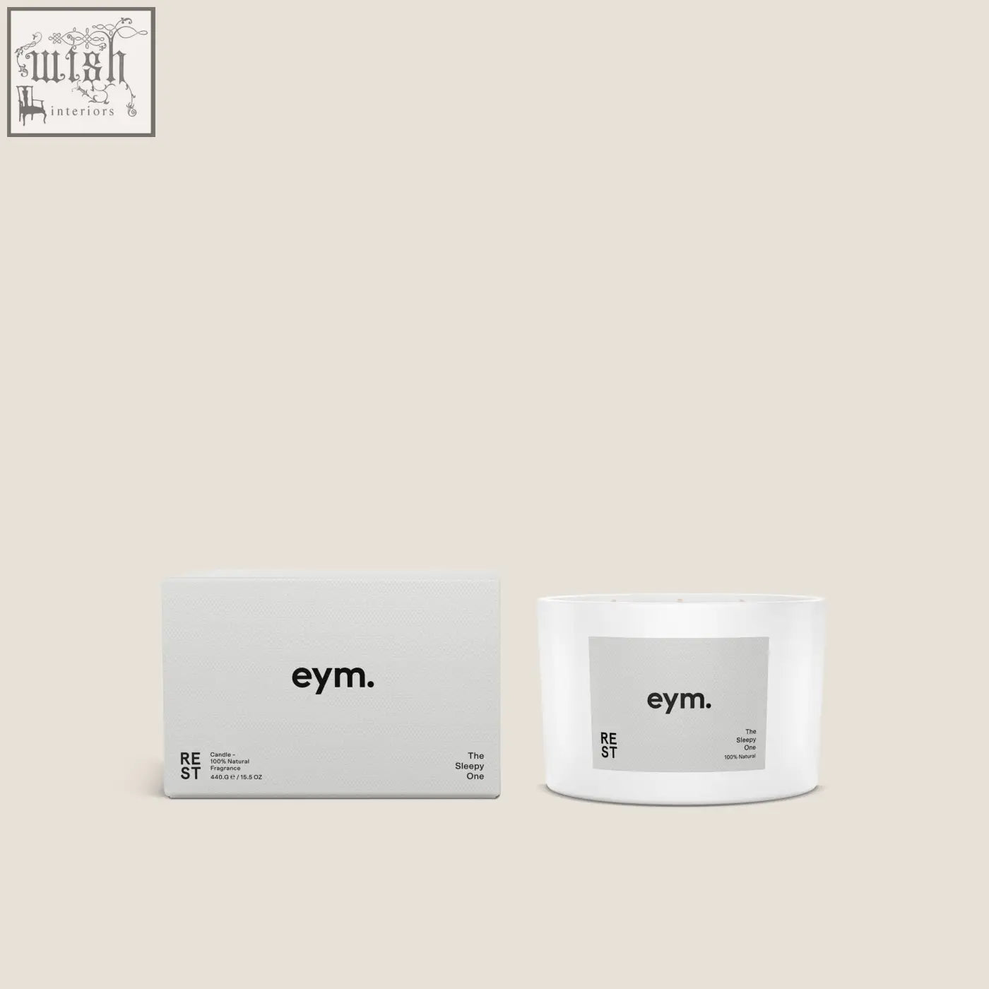 White cylindrical rest three wick candle with a minimalist gray eym label shown with its matching box