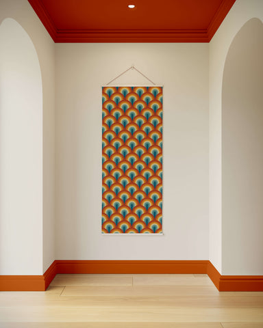 A retro rainbow tapestry featuring a vibrant orange and teal peacock feather pattern with a white border in art deco style