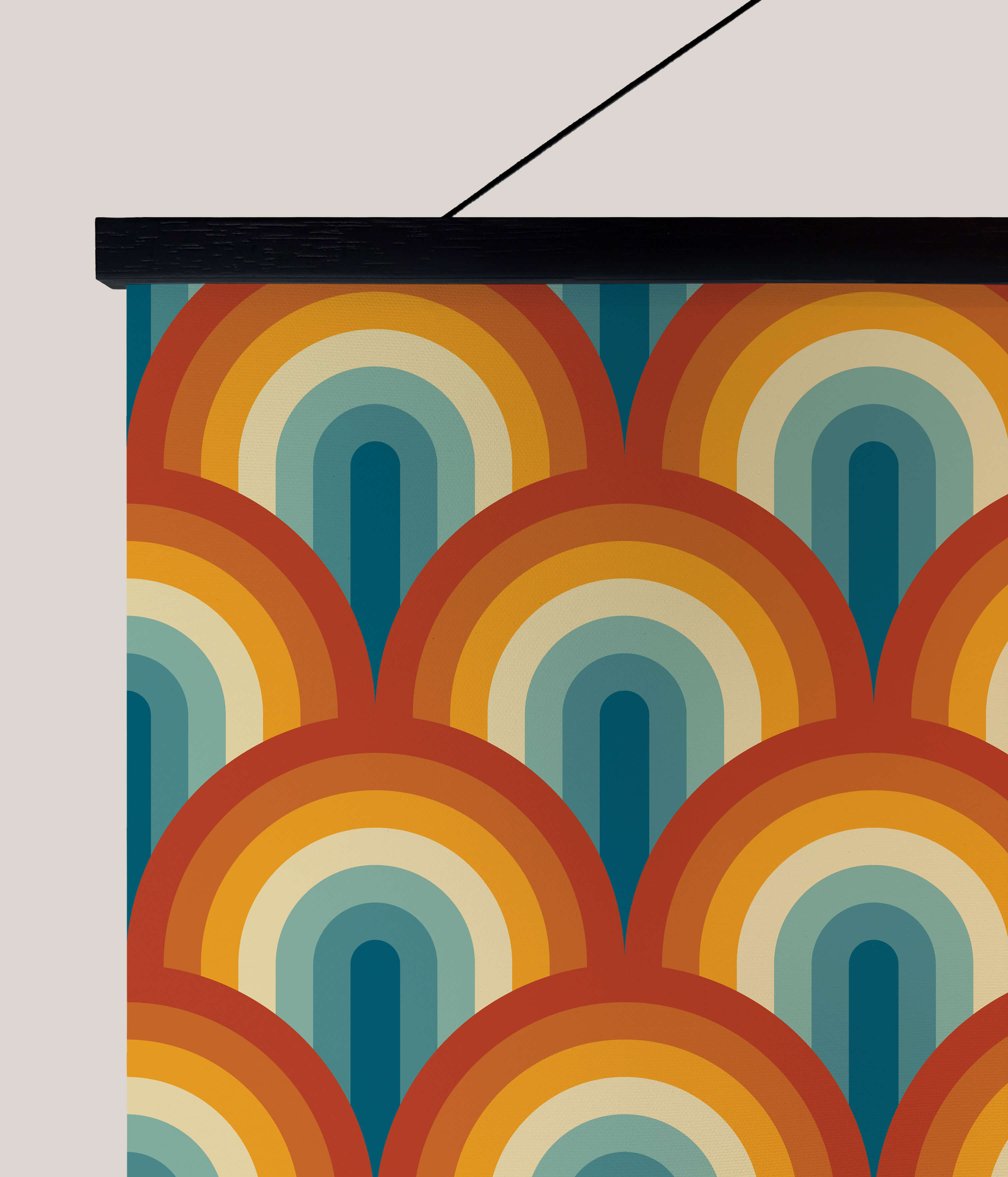 A vibrant retro rainbow tapestry with overlapping orange yellow teal and cream arches hanging on the wall