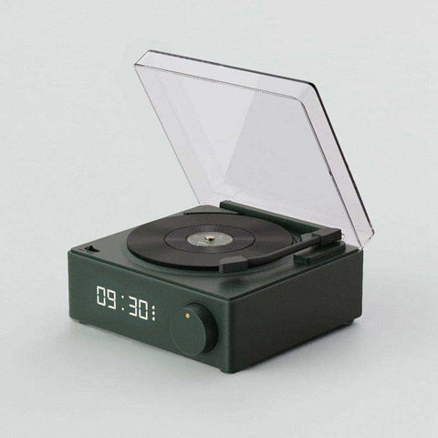 Dark green compact retro vinyl wireless bluetooth speaker with transparent lid and illuminated led display