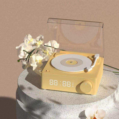 Yellow compact vinyl record player with transparent lid and digital display as a wireless bluetooth speaker