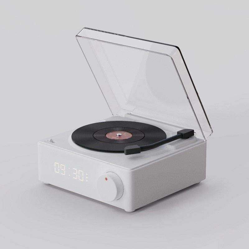 White rectangular retro vinyl wireless bluetooth speaker with transparent lid and black vinyl disc on turntable