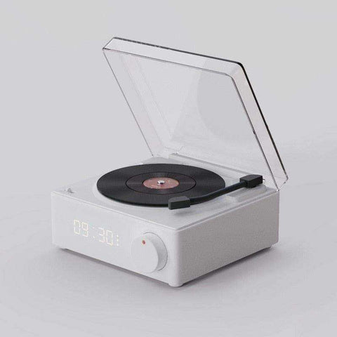 White rectangular retro vinyl wireless bluetooth speaker with transparent lid and black vinyl disc on turntable