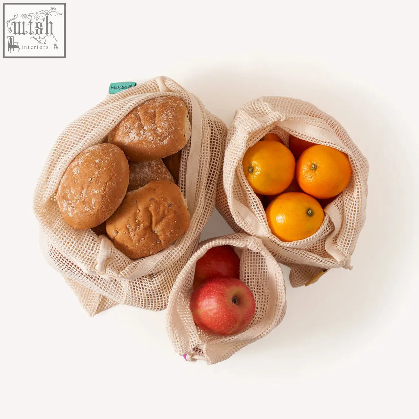 Beige organic cotton mesh produce bags with drawstring closures holding fresh fruit and bread reusable and eco-friendly