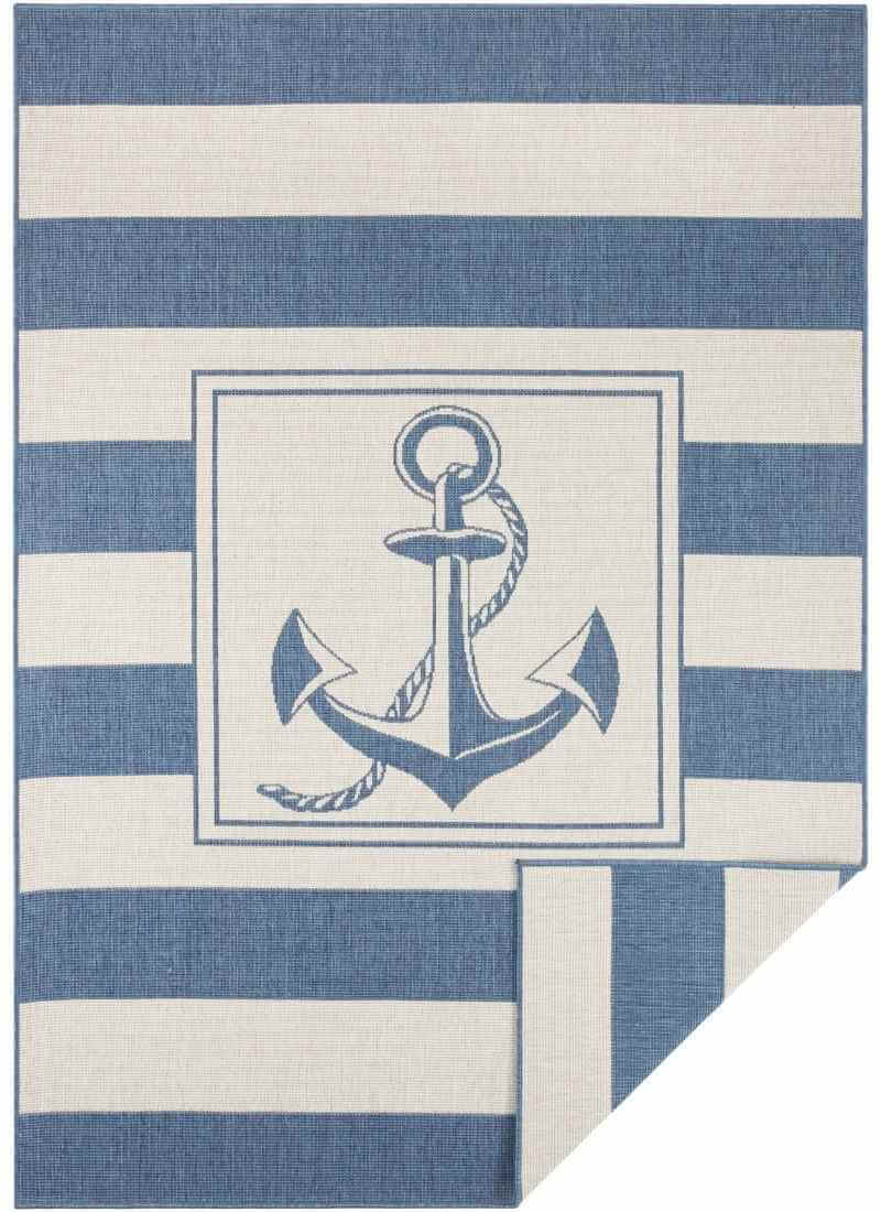 Reversible indoor-outdoor flatweave gandara rug with navy blue anchor and stripes on off-white nautical theme