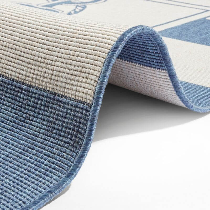 Blue and beige striped reversible indoor outdoor flatweave Gandara rug with textured ribbed woven surface