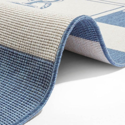 Blue and beige striped reversible indoor outdoor flatweave Gandara rug with textured ribbed woven surface