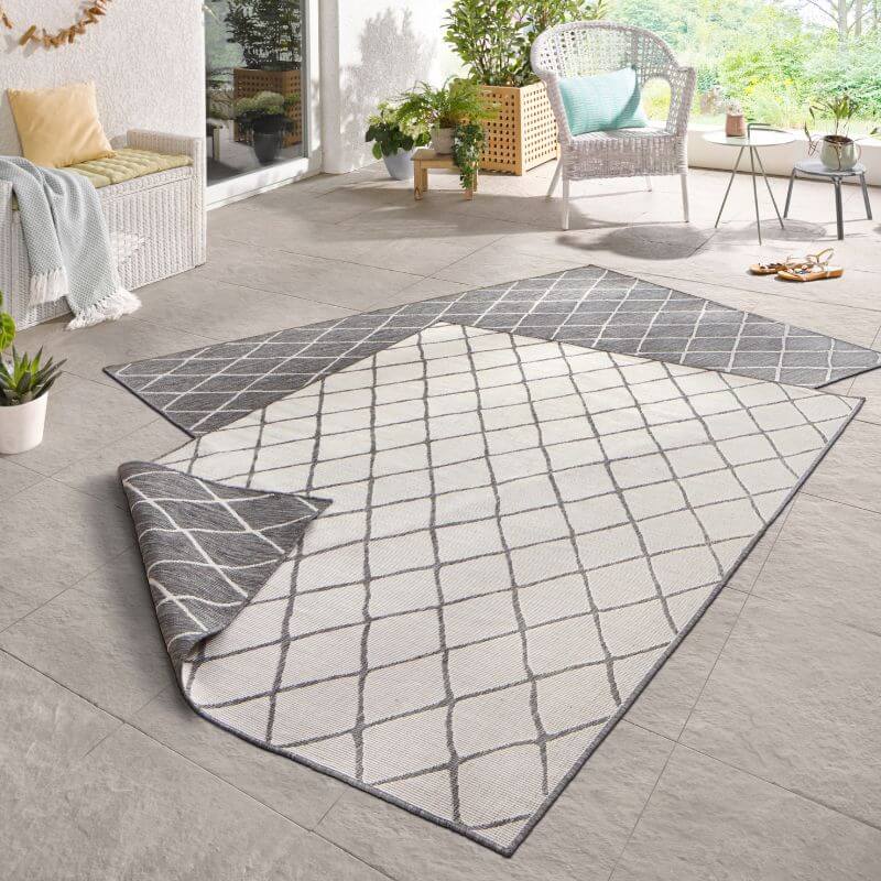 Gray and white geometric patterned reversible indoor outdoor flatweave rug with woven texture