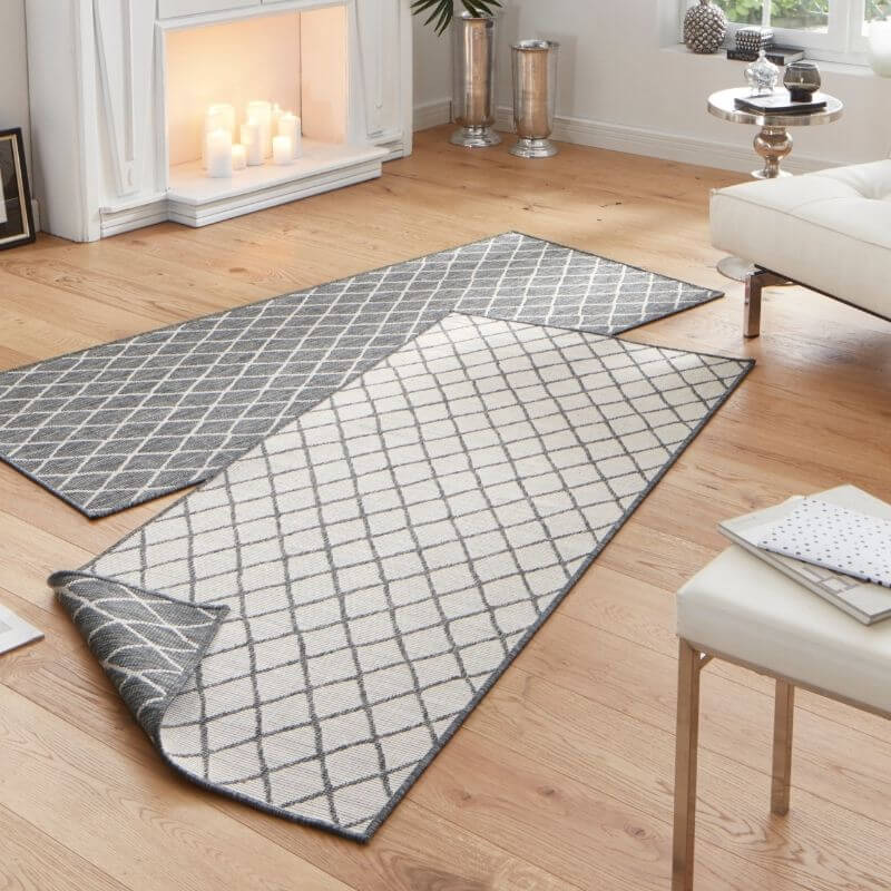 Reversible indoor-outdoor geometric flatweave runner rug with gray and white diamond pattern and textured weave