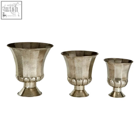 Set of three antique silver finish pedestal vases with fluted textured surfaces and classic urn shapes