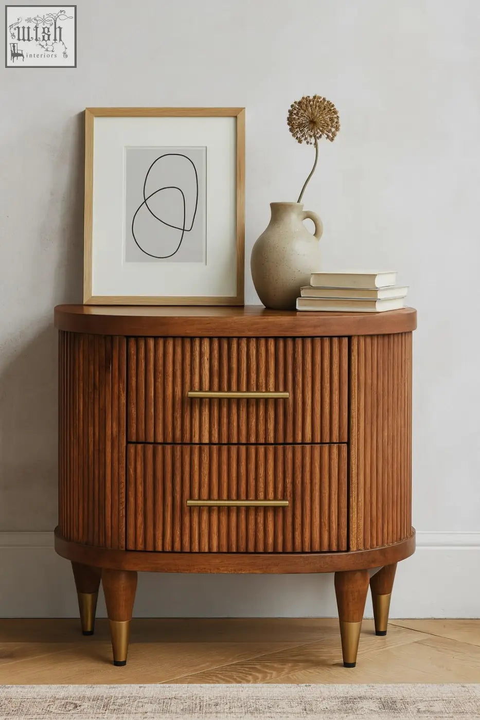 Curved wooden bedside table in solid mango wood with amber oak finish two ribbed-front drawers and brass accents