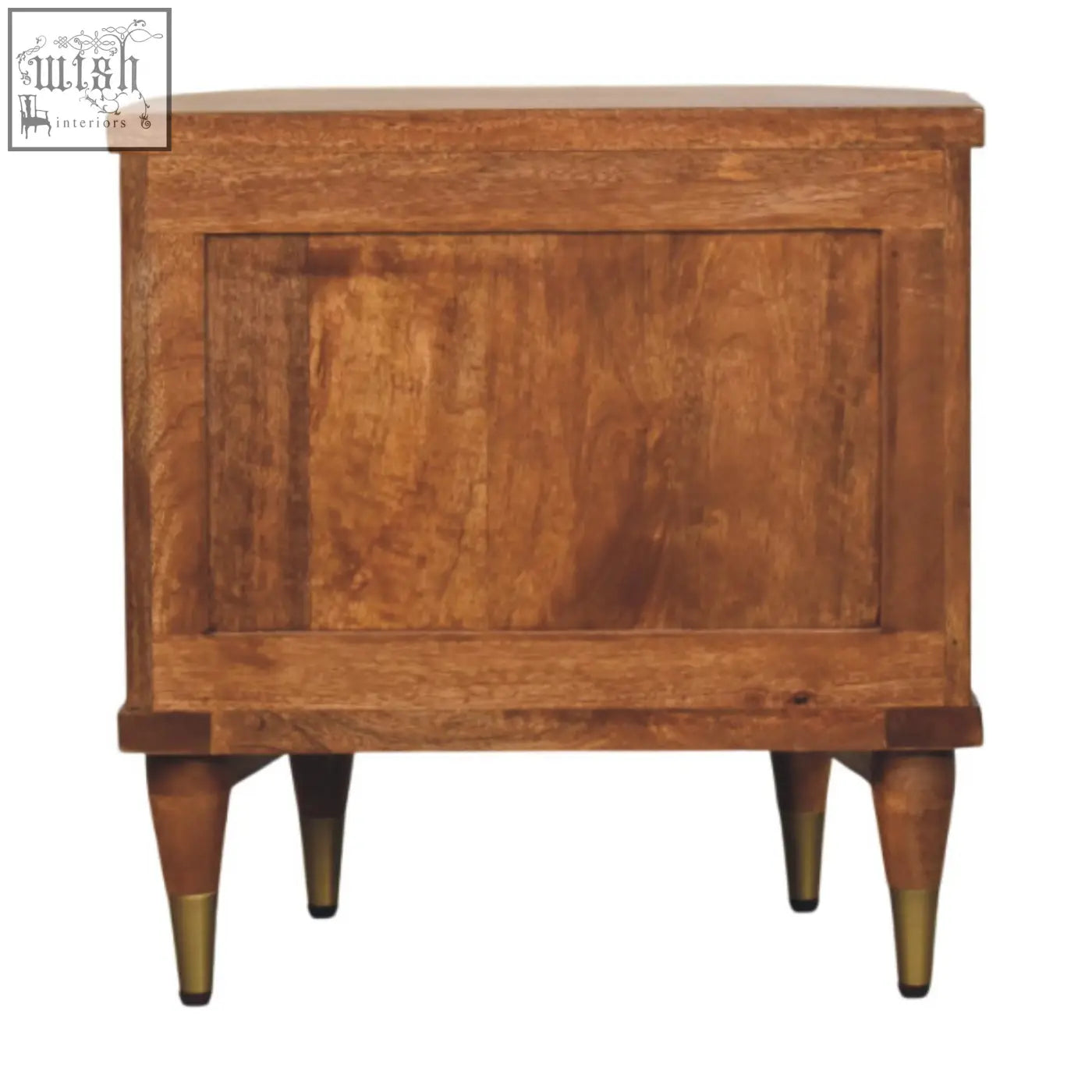 A rustic ribbed bedside table in solid mango wood with an amber oak finish and brass-tipped legs and two ribbed-front drawers