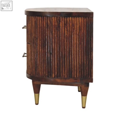 Dark wood ribbed bedside with vertical fluted panels and brass handles on tapered legs