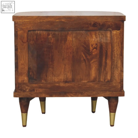 A rustic wooden ribbed bedside with brass handles, warm brown finish, brass-tipped legs, and visible wood grain