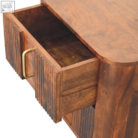 Ribera bedside table with rustic wooden drawer featuring a brass handle and vertical grooved paneling