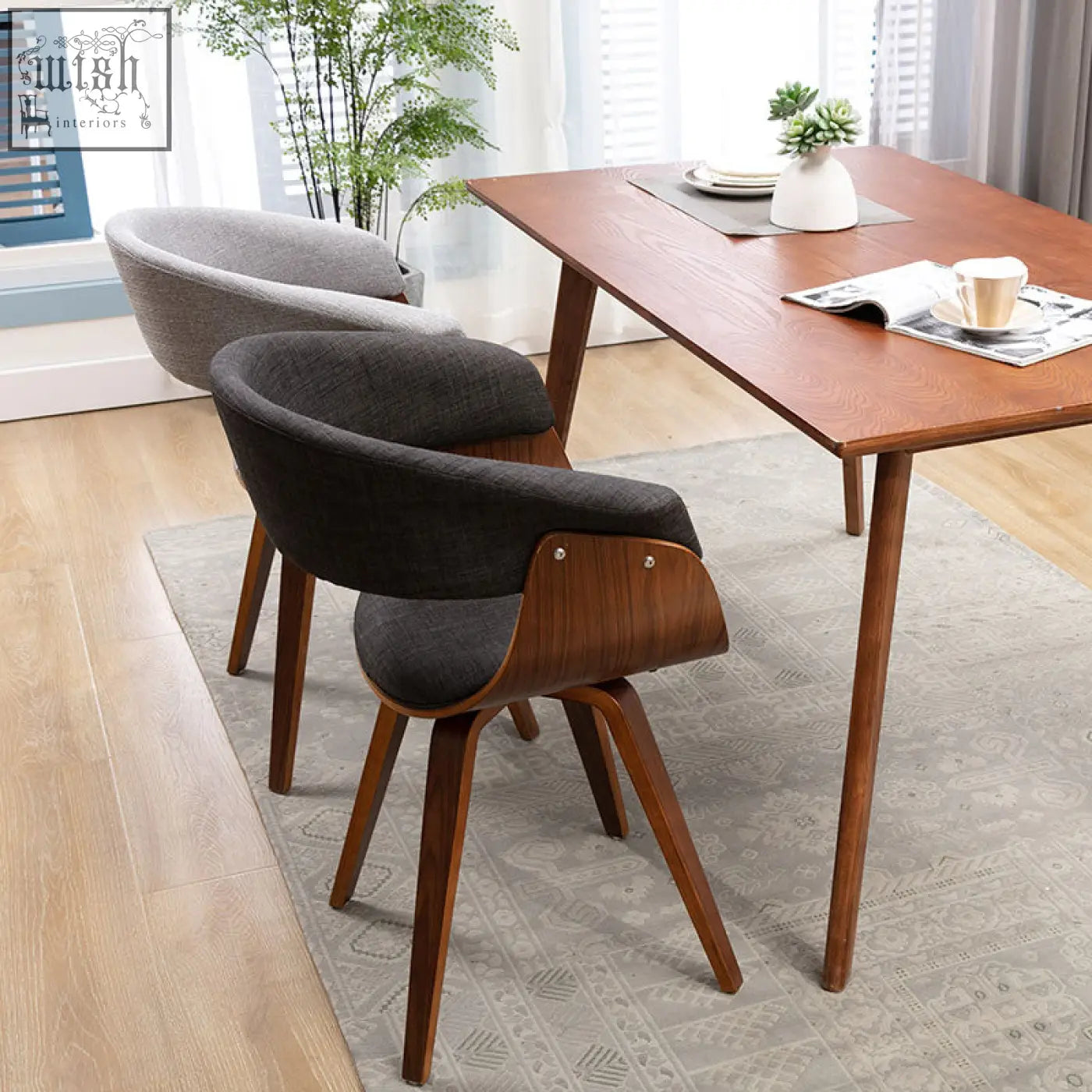 Modern richie dining chair with dark gray upholstered seat and backrest and warm brown wooden frame
