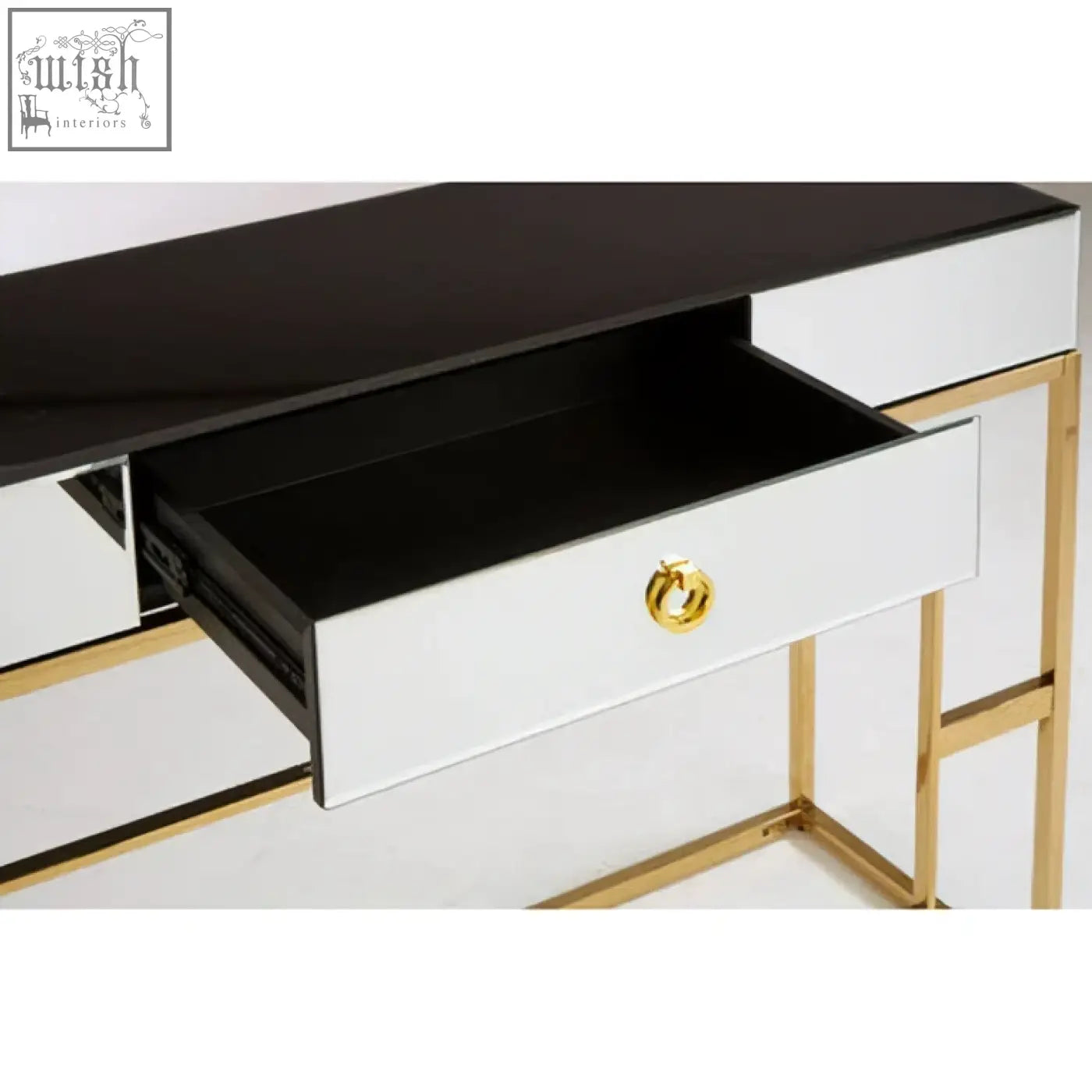A sleek rimini console table with a mirrored body, gold-tone frame, black top, and white drawers with brass handles