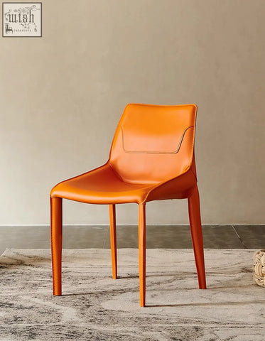 Rinaldi modern dining chair in sleek orange real leather with tapered legs perfect for stylish dining rooms and leather dining chairs