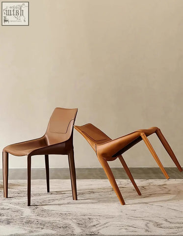 Two minimalist rinaldi modern dining chairs with real leather upholstery and dark brown wooden legs for dining room