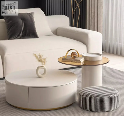 Cream-colored riviera round nesting coffee table with sleek minimalist design and gold-trimmed base in white