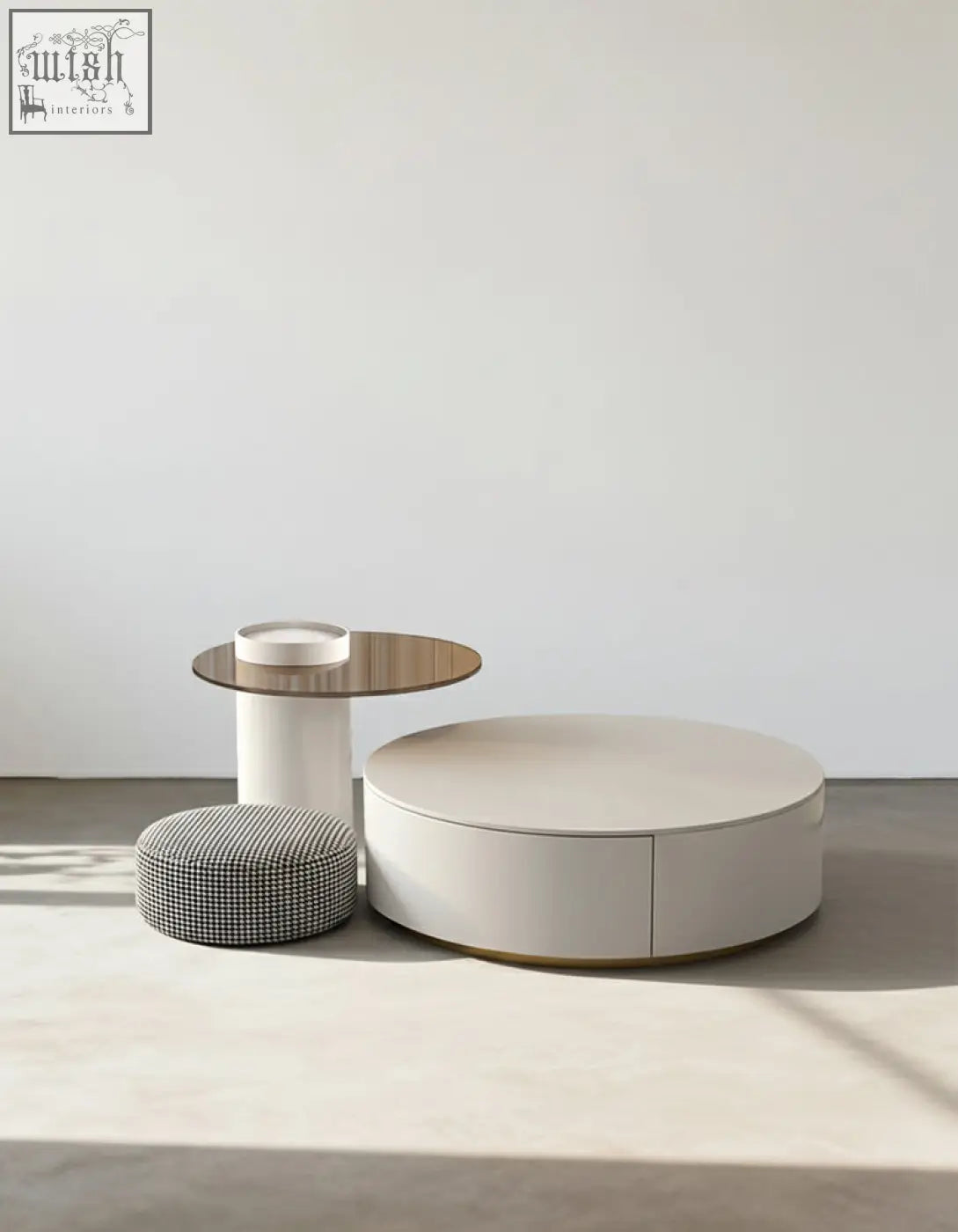 Cream-colored riviera round nesting coffee table with minimalist design and subtle gold trim along the base