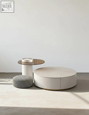Cream-colored riviera round nesting coffee table with minimalist design and subtle gold trim along the base