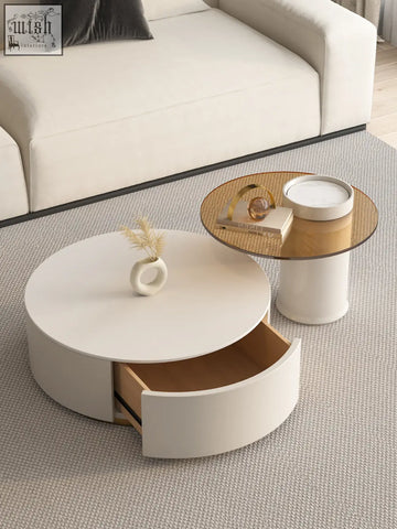 White riviera round nesting coffee table with sleek design and open drawer showing light wood interior