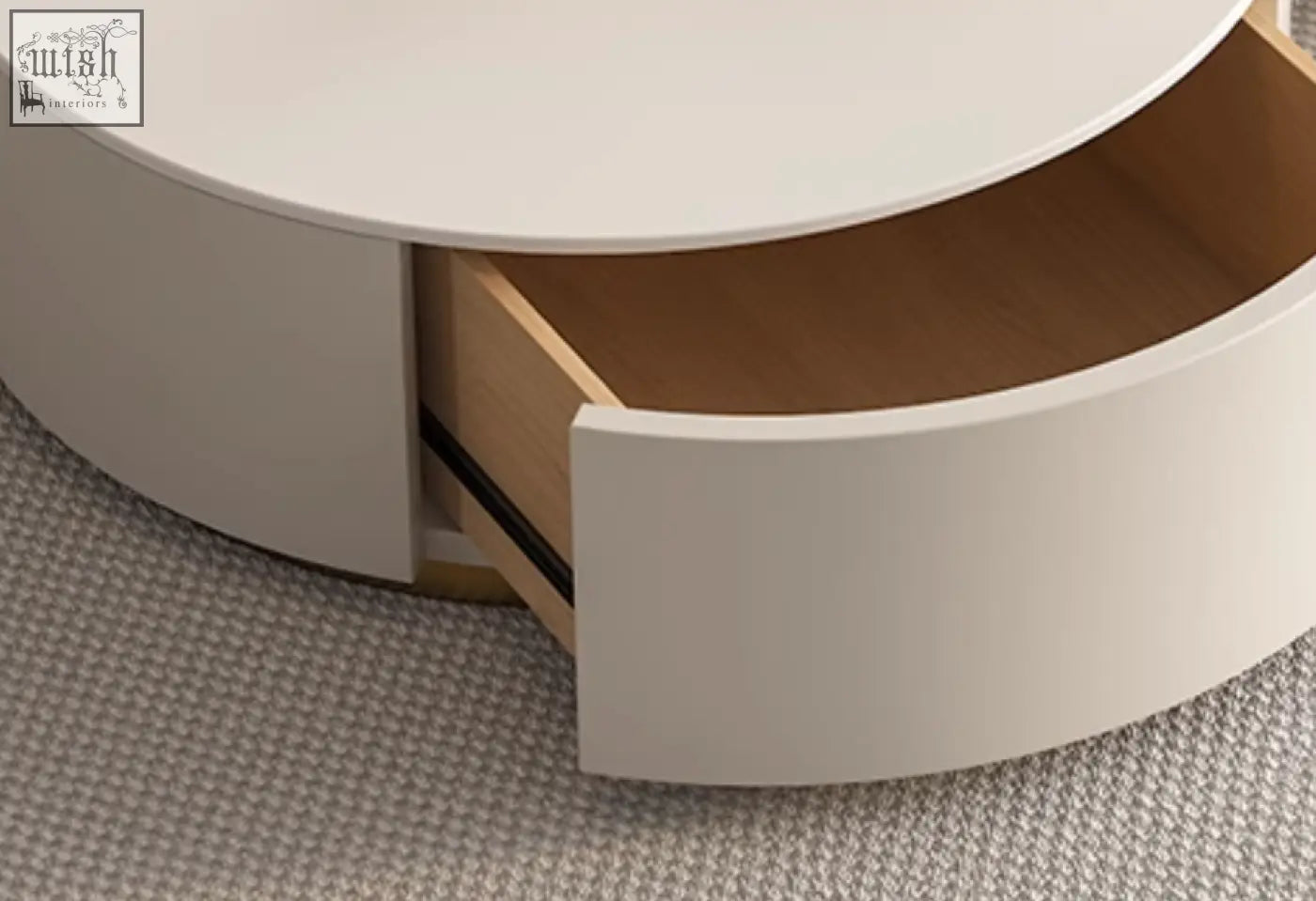 A sleek white riviera round nesting coffee table with curved drawer showing light wood interior in modern design