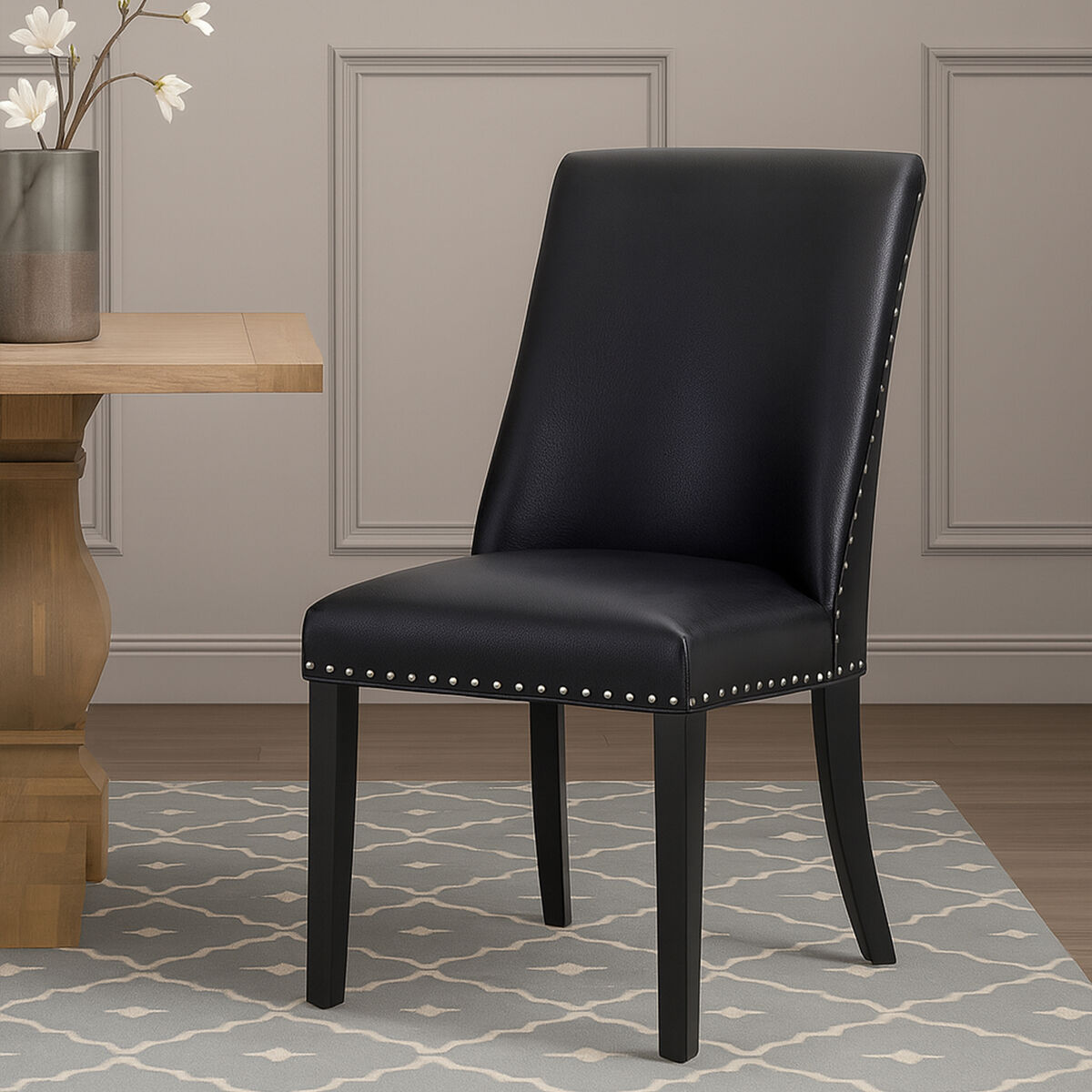 Rodeo black leather effect dining chair with silver nailhead trim and sleek black leather look