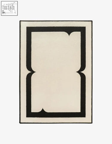 Cream colored rogers rectangular living room rug with bold black ornate border perfect for coffee table set areas