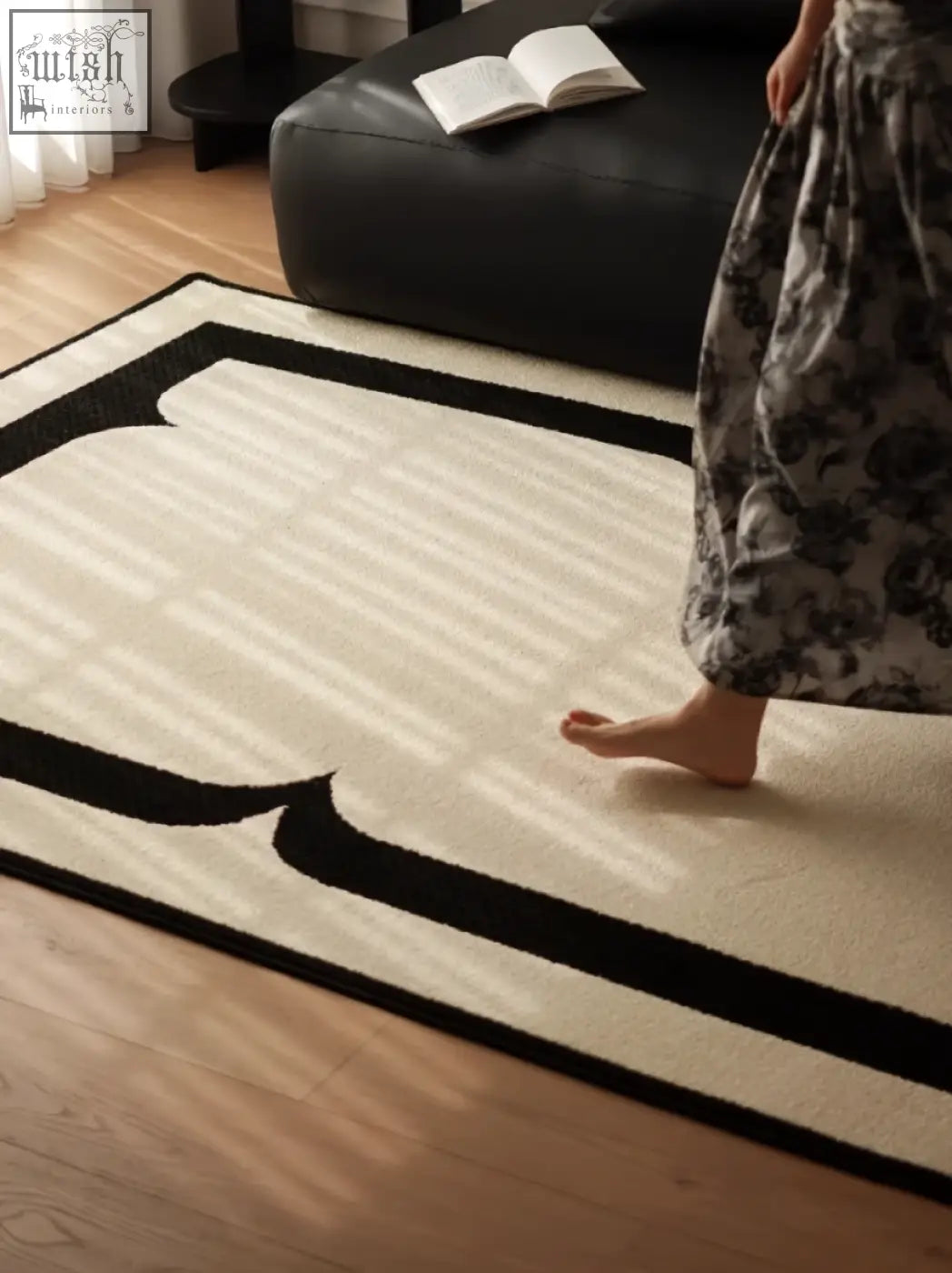 Cream-colored rogers rectangular living room rug with bold black geometric borders perfect for under a coffee table set